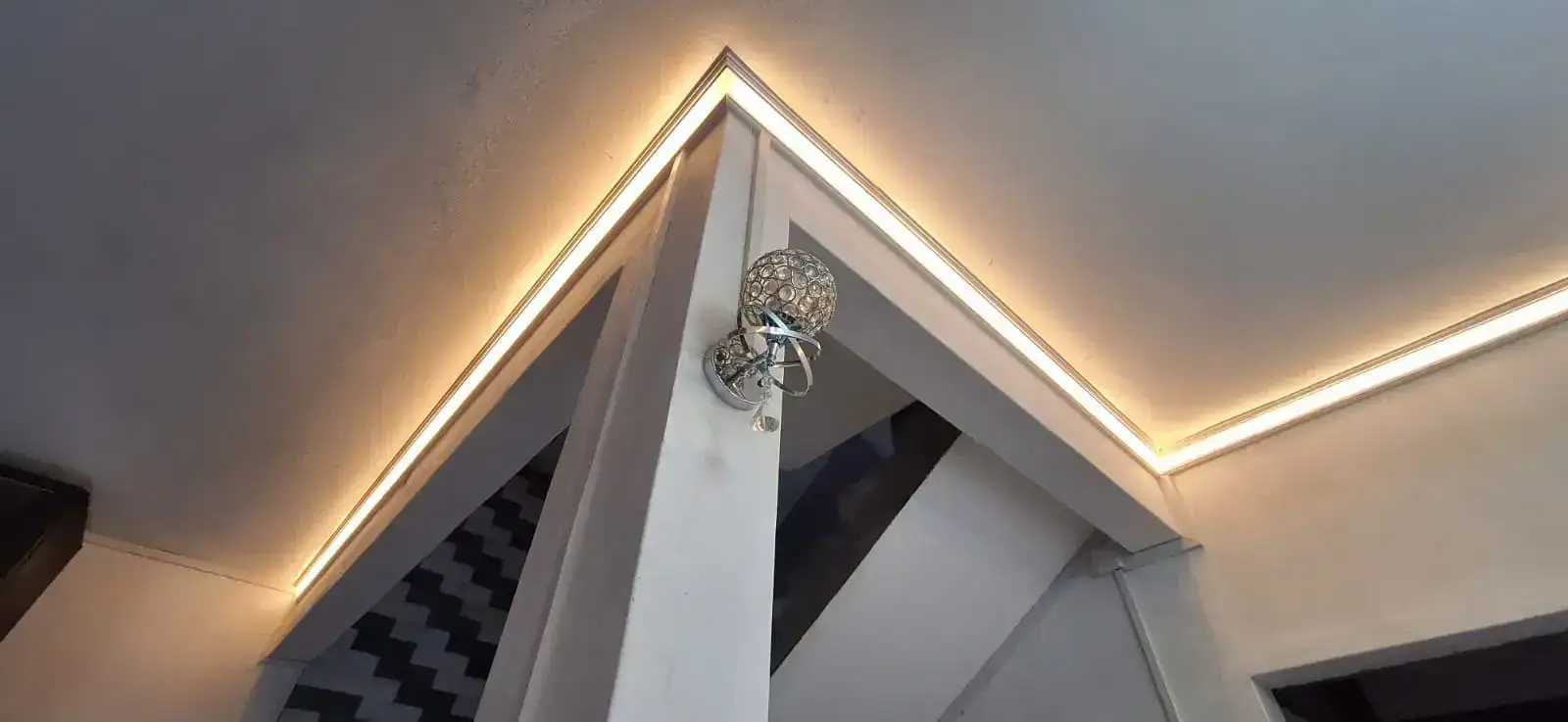 Warm cove lighting around a stair and ceiling detail