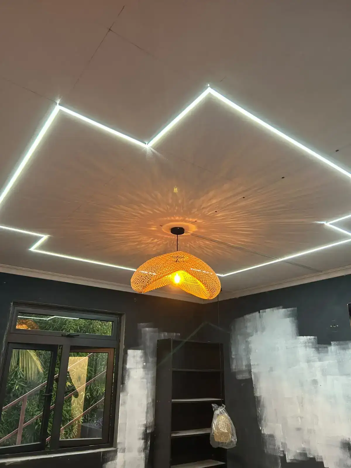 White linear lighting integrated into a wood ceiling